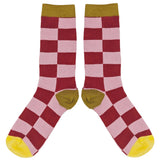 Checkered socks with red, pink, and yellow pattern on a white background