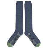 Pair of blue knee-high socks with green toes and heels on a white background
