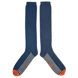 Pair of blue knee-high socks with orange toes and heel on a white background