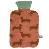 Knitted hot water bottle cover with dachshund pattern and green top on a white background