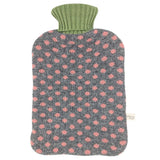 A knitted hot water bottle cover with a gray body patterned with pink flowers, featuring a ribbed sage green neck, shown against a plain white background.