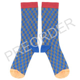 Pair of blue and gray checkered socks with red cuffs and orange toes on a white background.